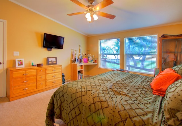 carpeted bedroom featuring ornamental molding and ceiling fan