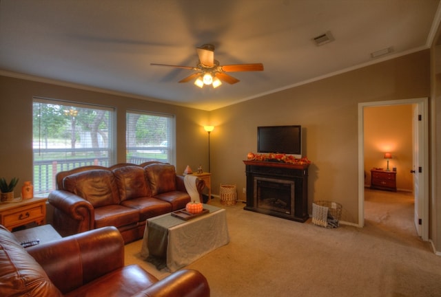 living room featuring ornamental molding, light carpet, and ceiling fan