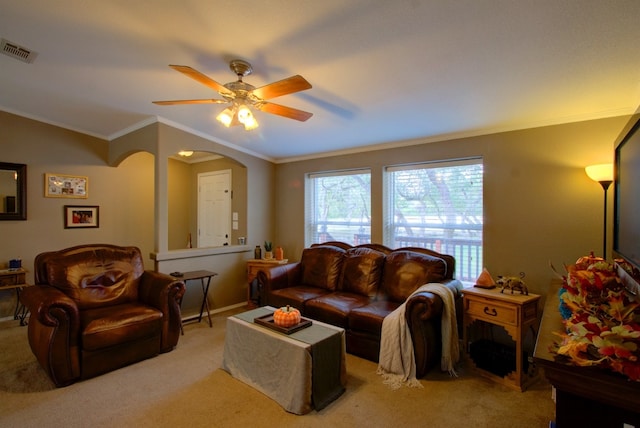 carpeted living room featuring ceiling fan and crown molding