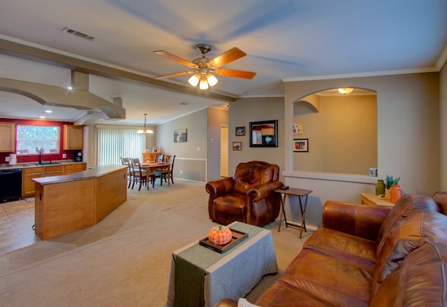 living room with ornamental molding, sink, ceiling fan, and light colored carpet