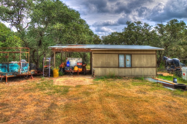 view of outbuilding with a yard