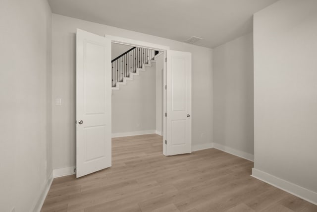 spare room with light wood-type flooring