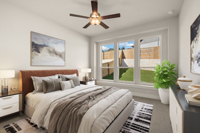 bedroom featuring ceiling fan and carpet