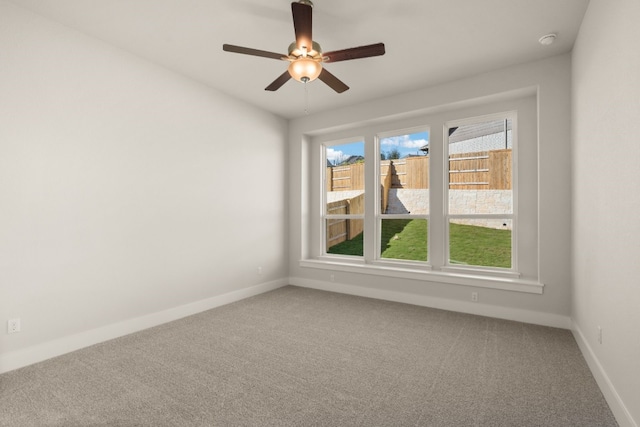 spare room with ceiling fan and carpet floors