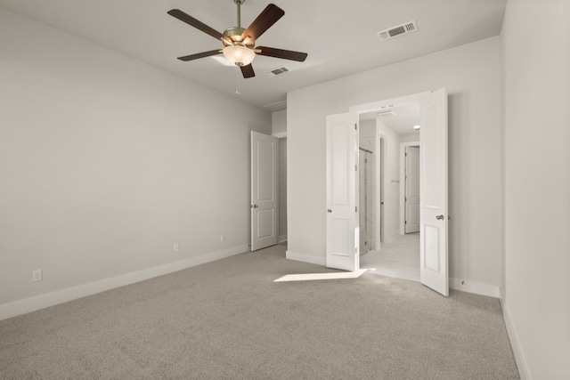 unfurnished bedroom featuring ceiling fan and light colored carpet