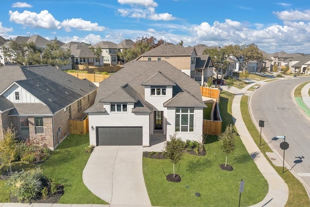 view of front of home with a garage and a front lawn