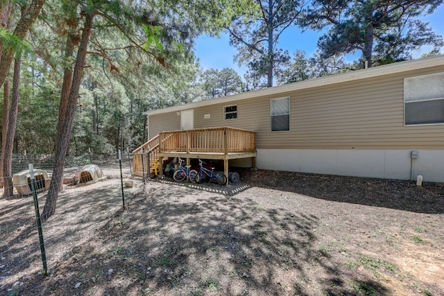 rear view of house featuring a wooden deck