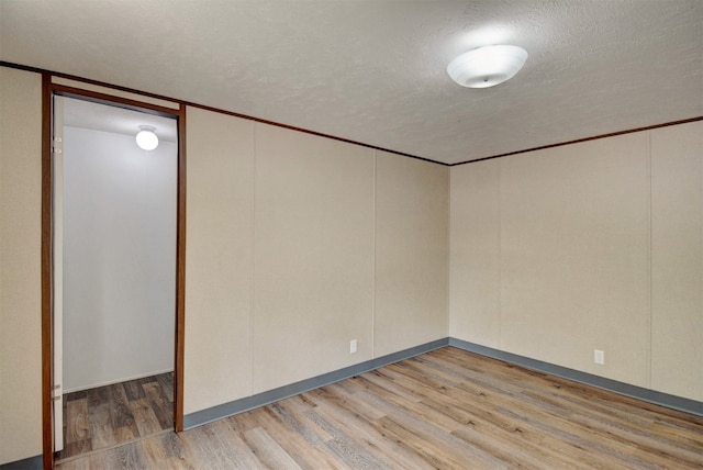 unfurnished room featuring a textured ceiling and hardwood / wood-style flooring