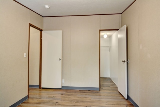 unfurnished bedroom featuring a textured ceiling and light wood-type flooring