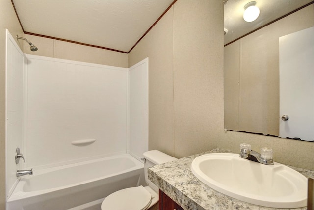 full bathroom with bathing tub / shower combination, vanity with extensive cabinet space, toilet, and a textured ceiling