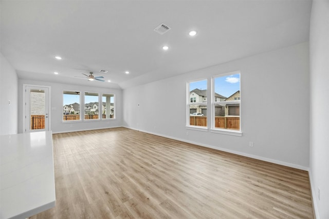 unfurnished living room featuring ceiling fan and light hardwood / wood-style flooring