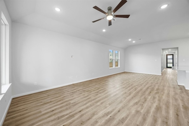 unfurnished living room with ceiling fan, light wood-type flooring, and lofted ceiling