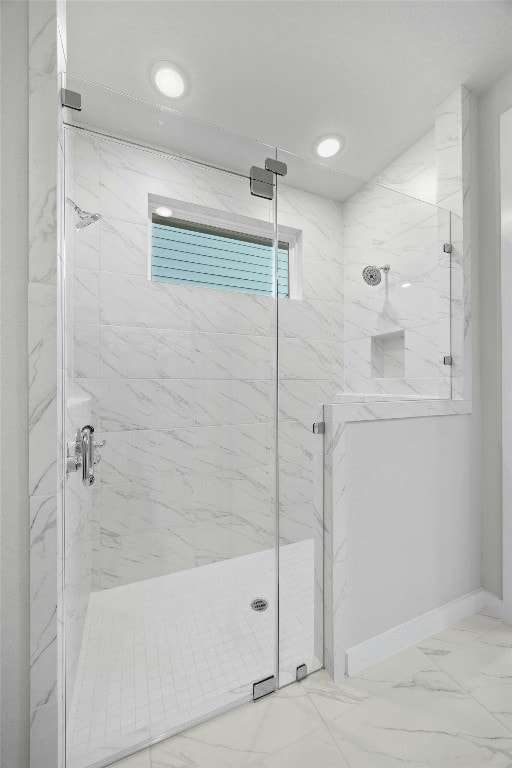 bathroom featuring a shower with shower door