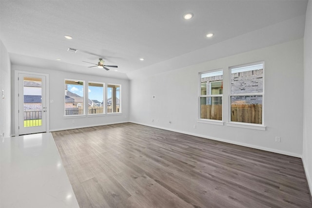 unfurnished living room featuring ceiling fan and dark hardwood / wood-style flooring