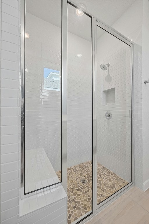 bathroom with a shower with shower door