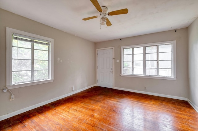 spare room featuring hardwood / wood-style flooring and ceiling fan