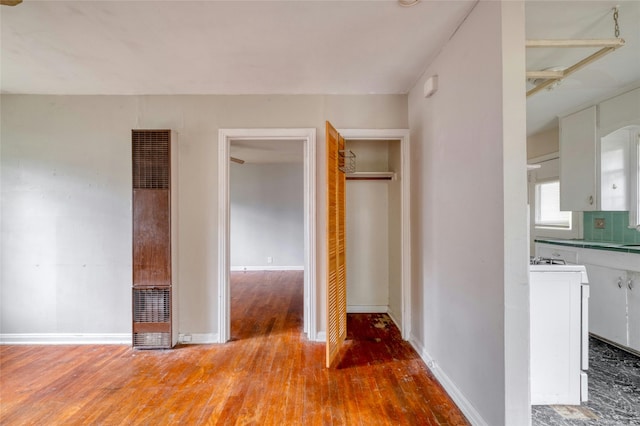 interior space featuring ensuite bathroom, washer / clothes dryer, and hardwood / wood-style floors