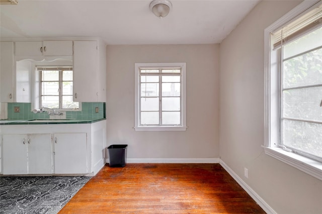 kitchen featuring a wealth of natural light, sink, and backsplash