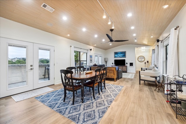 dining space featuring light hardwood / wood-style flooring, ceiling fan, rail lighting, french doors, and lofted ceiling