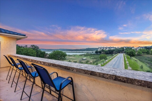 patio terrace at dusk with a water view