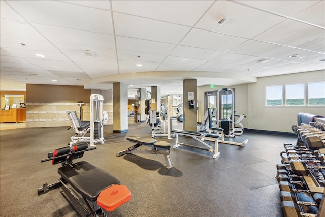 gym with a paneled ceiling