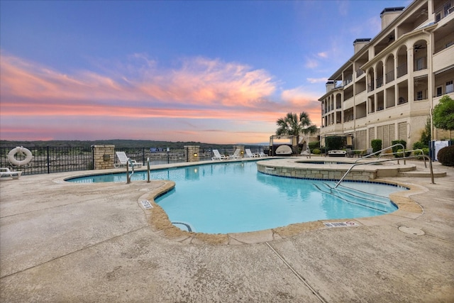 pool at dusk with a patio