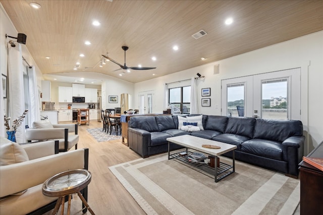 living room with vaulted ceiling, ceiling fan, light wood-type flooring, wood ceiling, and french doors