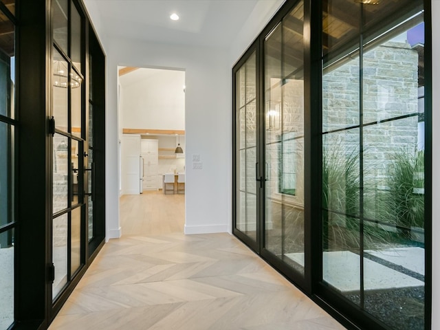 hallway with light parquet flooring and french doors