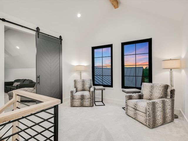 carpeted bedroom with a barn door and lofted ceiling with beams