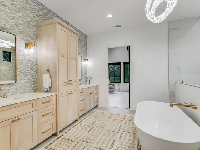 bathroom featuring tile floors, vanity, and a bathing tub