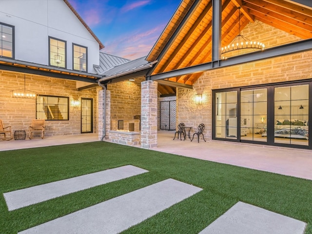 yard at dusk with a patio area