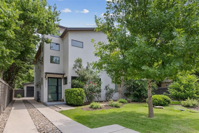 view of front of property with a front yard and a garage