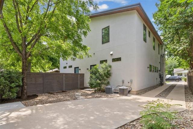 back of property with a patio area and central air condition unit