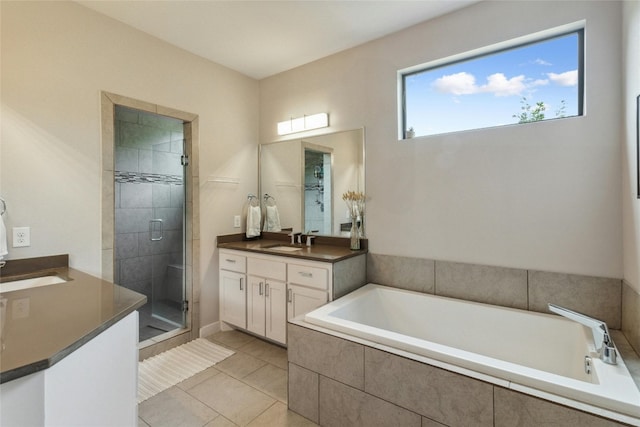 bathroom featuring plus walk in shower, tile flooring, and vanity