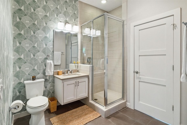 bathroom with tile floors, a shower with door, toilet, and oversized vanity