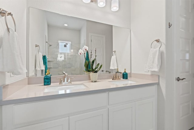 bathroom featuring a tile shower and vanity