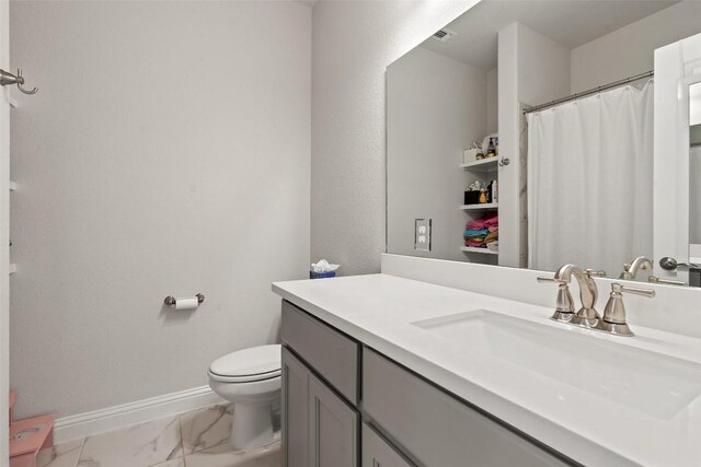 bathroom featuring vanity and toilet