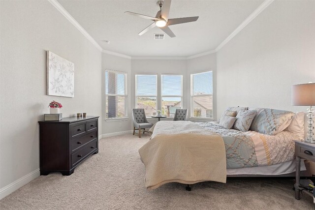 carpeted bedroom featuring crown molding and ceiling fan