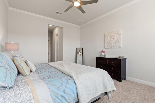 carpeted bedroom with ornamental molding and ceiling fan