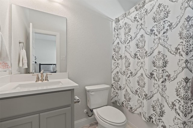 full bathroom featuring vanity, shower / tub combo, and toilet