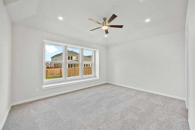 carpeted spare room with ceiling fan