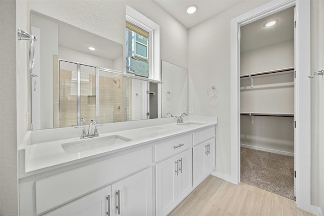 bathroom featuring vanity and a shower with shower door