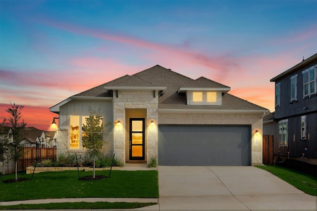 view of front of home with a yard and a garage