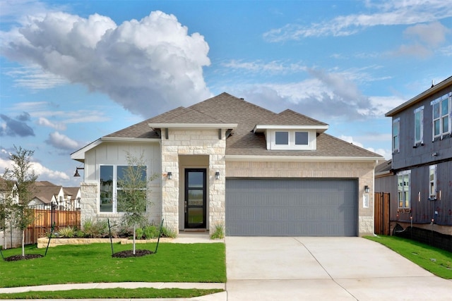 view of front facade with a front yard and a garage