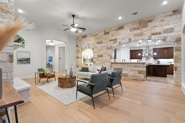 living room with ceiling fan and light hardwood / wood-style flooring