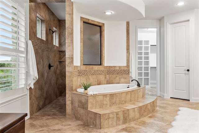 bathroom featuring tile patterned flooring and plus walk in shower