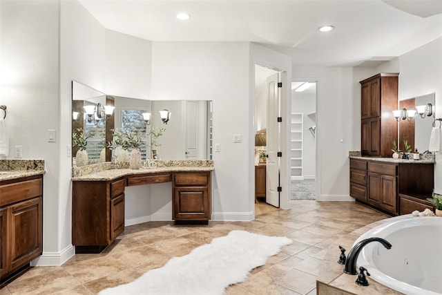 bathroom with vanity and a relaxing tiled tub