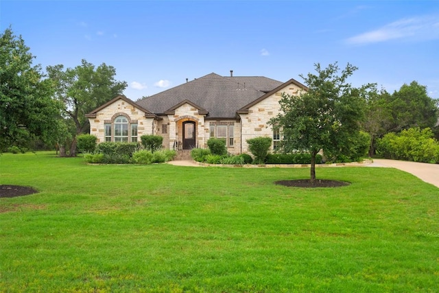 french country home with a front lawn