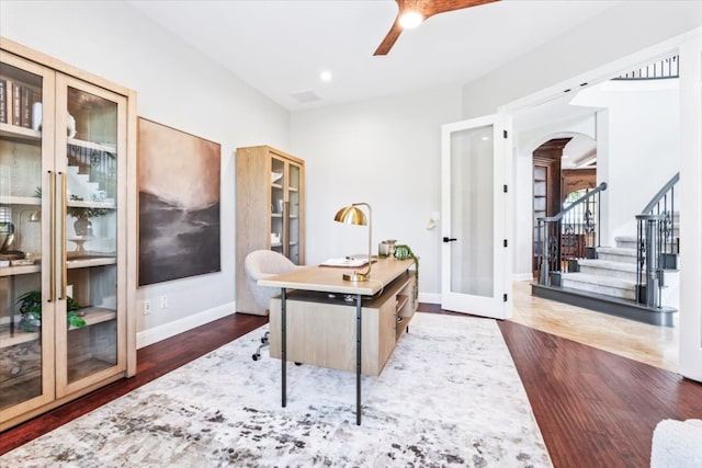 office featuring dark wood-type flooring, ceiling fan, and french doors