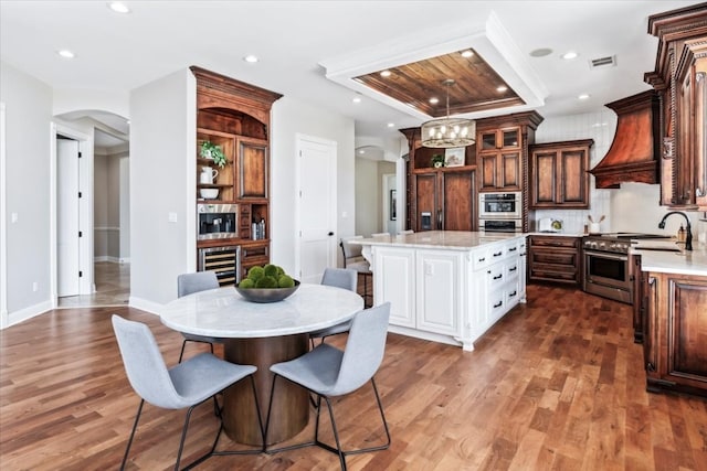 dining space featuring hardwood / wood-style flooring and wine cooler